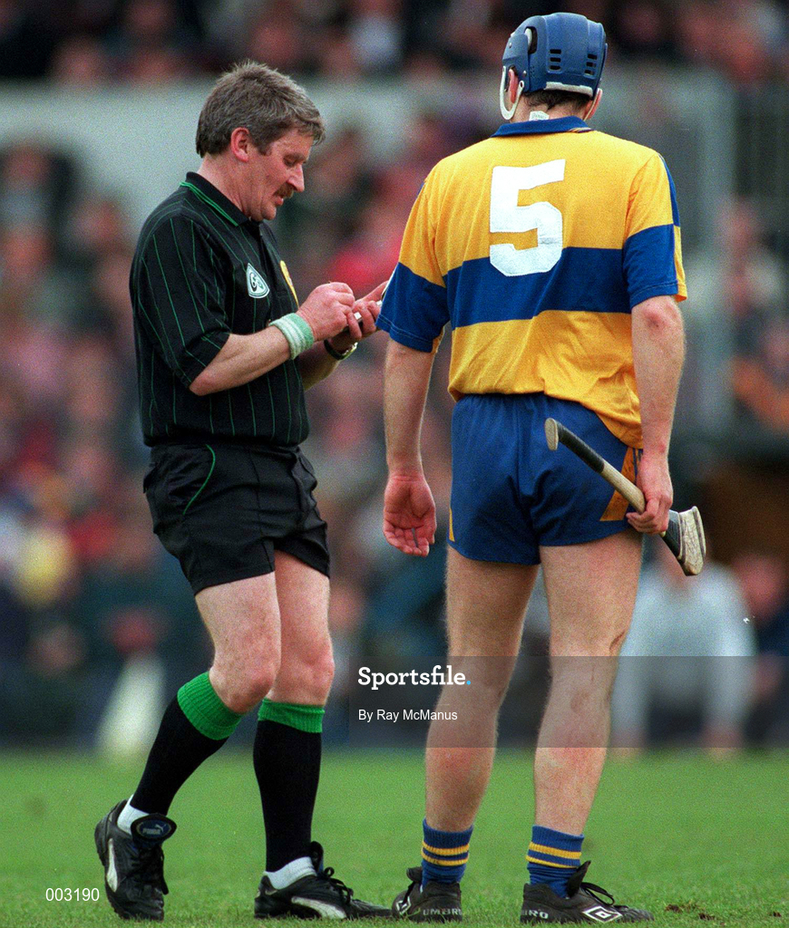10 May 1997; Referee Pat Horan books Liam Doyle of Clare during the National Hurling League Division 1 match between Clare and Tipperary at Cusack Park in Ennis. Photo by Ray McManus/Sportsfile