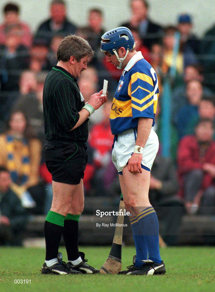 10 May 1997; Referee Pat Horan books John Leahy of Tipperary during the National Hurling League Division 1 match between Clare and Tipperary at Cusack Park in Ennis. Photo by Ray McManus/Sportsfile