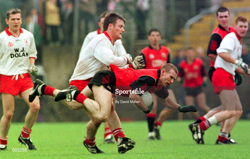 18 May 1997; Ross Carr of Down is tackled by Seamus McCallan of Tyrone during the Ulster GAA Football Senior Championship Preliminary Round match between Down and Tyrone at St. Tiernach's Park in Clones. Photo by David Maher/Sportsfile