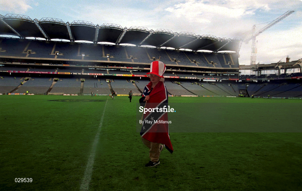 26 September 1999; A young Cork supporter makes his way off the pitch following the Bank of Ireland All-Ireland Senior Football Championship Final match between Meath and Cork at Croke Park in Dublin. Photo by Ray McManus/Sportsfile