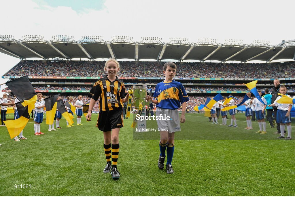 7 September 2014; Diarmuid O'Carroll, Donaskeigh NS, Co. Tipperary and Aoife Mulhall, St. Joseph's NS, Clinstown, Co. Kilkenny, carry out the Liam MacCarthy Cup before the game. GAA Hurling All Ireland Senior Championship Final, Kilkenny v Tipperary. Croke Park, Dublin. Picture credit: Ramsey Cardy / SPORTSFILE