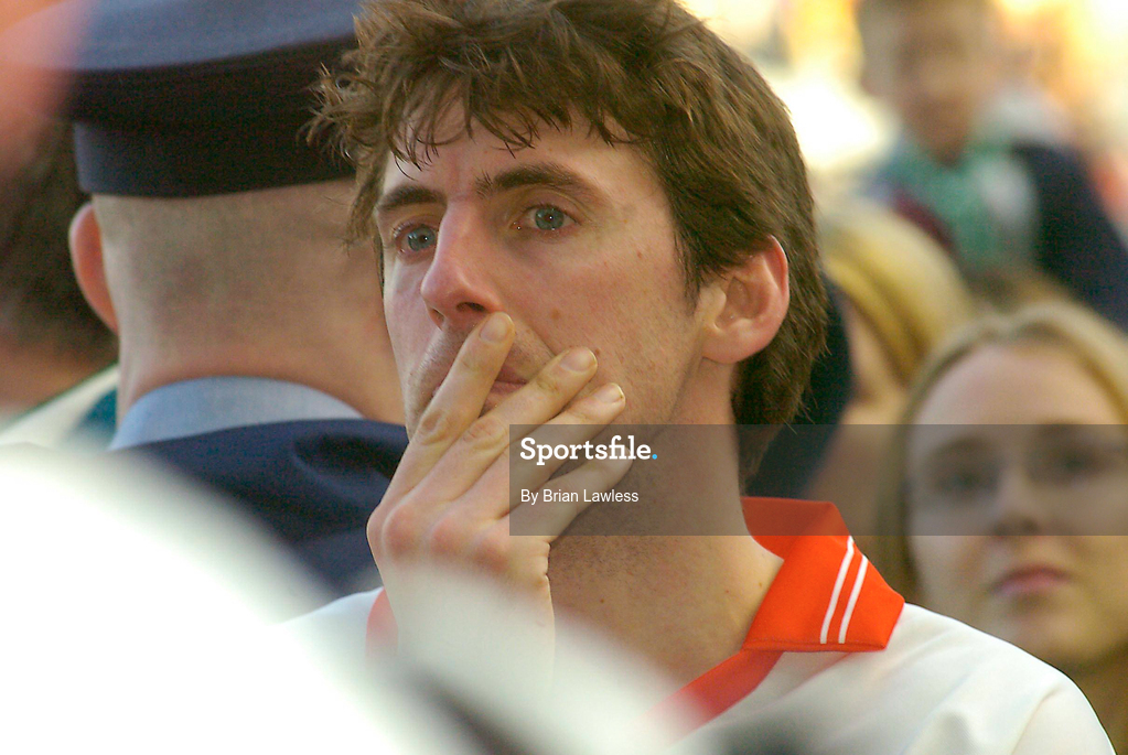 17 March 2004; A dejected Cathal O Dubhda of An Ghaeltacht watches on as Caltra are presented with the Tommy Moore Cup following the AIB All-Ireland Senior Club Football Championship Final between An Gaeltacht and Caltra at Croke Park in Dublin. Photo by Brian Lawless/Sportsfile
