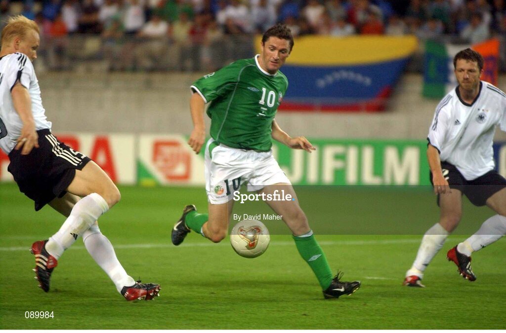 5 June 2002; Robbie Keane, Republic of Ireland, slips past Germany's Carsten Jancker, left, and Thomas Linke to score his sides late equaliser. FIFA World Cup Finals, Group E, Republic of Ireland v Germany, Ibaraki Stadium, Ibaraki, Japan. Picture credit: David Maher / SPORTSFILE