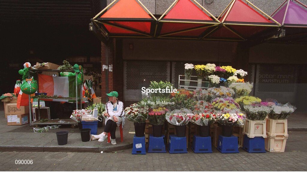 5 June 2002; Flower seller Rose Kinsella relaxes on Dublin's Moore Street during the Republic of Ireland v Germany game at the FIFA World Cup Finals. Moore Street, Dublin. Picture credit: Ray McManus / SPORTSFILE