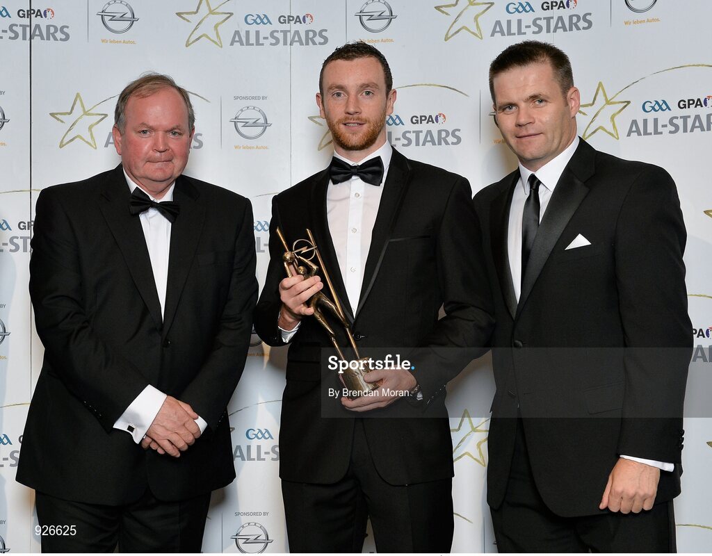 24 October 2014; Mayo footballer Keith Higgins is presented with his 2014 GAA GPA All-Star award by Uachtarán Chumann Lúthchleas Gael Liam Ó Néill and Dessie Farrell, Chief Executive of the Gaelic Players Association. GAA GPA All-Star Awards 2014 Sponsored by Opel. Convention Centre, Dublin. Picture credit: Brendan Moran / SPORTSFILE