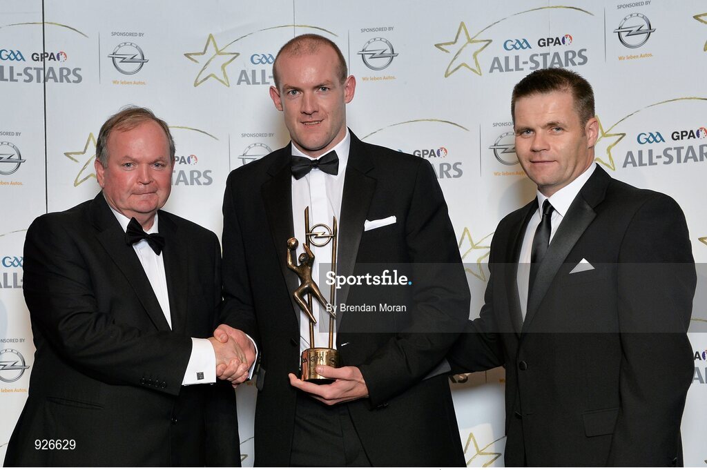 24 October 2014; Donegal footballer Neil Gallagher is presented with his 2014 GAA GPA All-Star award by Uachtarán Chumann Lúthchleas Gael Liam Ó Néill and Dessie Farrell, Chief Executive of the Gaelic Players Association. GAA GPA All-Star Awards 2014 Sponsored by Opel. Convention Centre, Dublin. Picture credit: Brendan Moran / SPORTSFILE