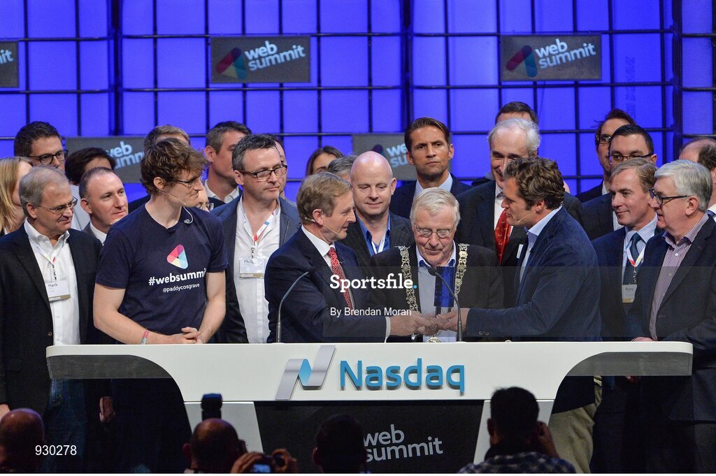 4 November 2014; An Taoiseach Enda Kenny, centre, receives a presentation from Adam KostyÃ¡l, Senior VP,Global Corporate Client Group and head of European Listings, NASDAQ OMX, after ringing the NASDAQ bell watched by Paddy Cosgrave, Founder and CEO, Web Summit, left and Cllr Christy Burke, Lord Major of Dublin, centre, on the centre stage during Day 1 of the 2014 Web Summit in the RDS, Dublin, Ireland. Picture credit: Brendan Moran / SPORTSFILE / Web Summit