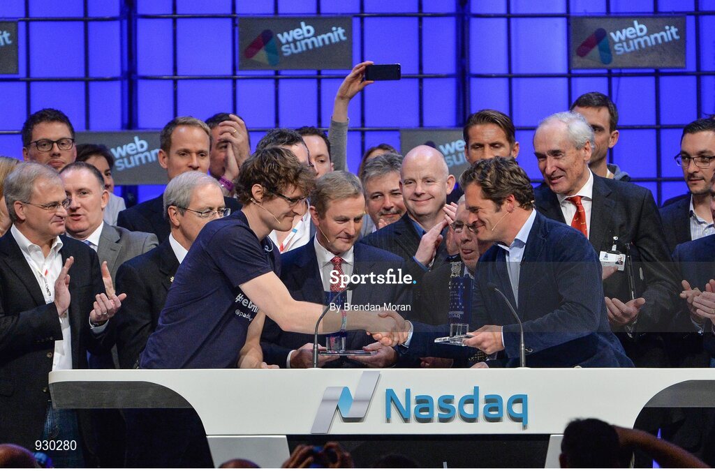 4 November 2014; Paddy Cosgrave, Founder and CEO, Web Summit, receives a presentation from Adam KostyÃ¡l, Head of European Listings, NASDAQ OMX, after An Taoiseach Enda Kenny, centre, rang the NASDAQ bell on the centre stage during Day 1 of the 2014 Web Summit in the RDS, Dublin, Ireland. Picture credit: Brendan Moran / SPORTSFILE / Web Summit