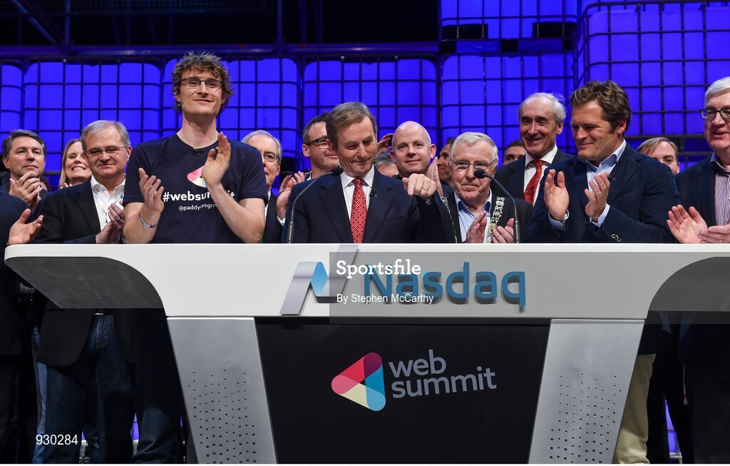 4 November 2014; An Taoiseach Enda Kenny, centre, rings the NASDAQ bell watched by, from left: Paddy Cosgrave, Founder and CEO, Web Summit; Cllr Christy Burke, Lord Major of Dublin; and Adam KostyÃ¡l, head of European Listings, NASDAQ OMX, on the centre stage during Day 1 of the 2014 Web Summit in the RDS, Dublin, Ireland. Picture credit: Stephen McCarthy / SPORTSFILE / Web Summit