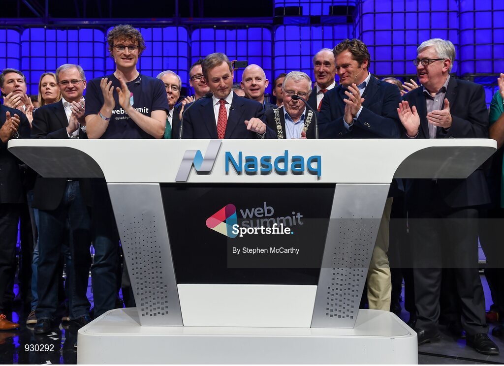 4 November 2014; An Taoiseach Enda Kenny, centre, rings the NASDAQ bell watched by, from left: Paddy Cosgrave, Founder and CEO, Web Summit; Cllr Christy Burke, Lord Major of Dublin; and Adam KostyÃ¡l, head of European Listings, NASDAQ OMX, on the centre stage during Day 1 of the 2014 Web Summit in the RDS, Dublin, Ireland. Picture credit: Stephen McCarthy / SPORTSFILE / Web Summit