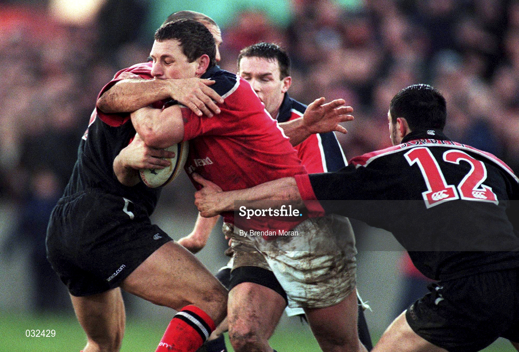 8 January 2000; Munster's Jason Holland is tackled by theirry Lacroix and Kevin Sorrell of Saracens during the Heineken Cup Pool 4 Round 5 match between Munster and Saracens at Thomond Park in Limerick. Photo by Brendan Moran/Sportsfile