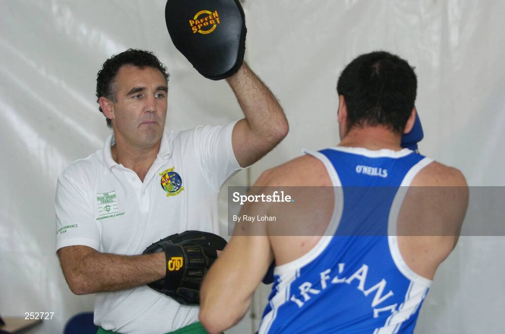 19 June 2006: Ireland’s Head coach Billy Walsh warms up John Sweeney before the start of his fight against John-Michael M’Bumba, France. 5th European Union Boxing Championships, Heavy Weight 91kg Premliminary Round, John Sweeney, Ireland v John-Michael M’bumba, France, National Stadium, Dublin. Picture credit: Ray Lohan / SPORTSFILE