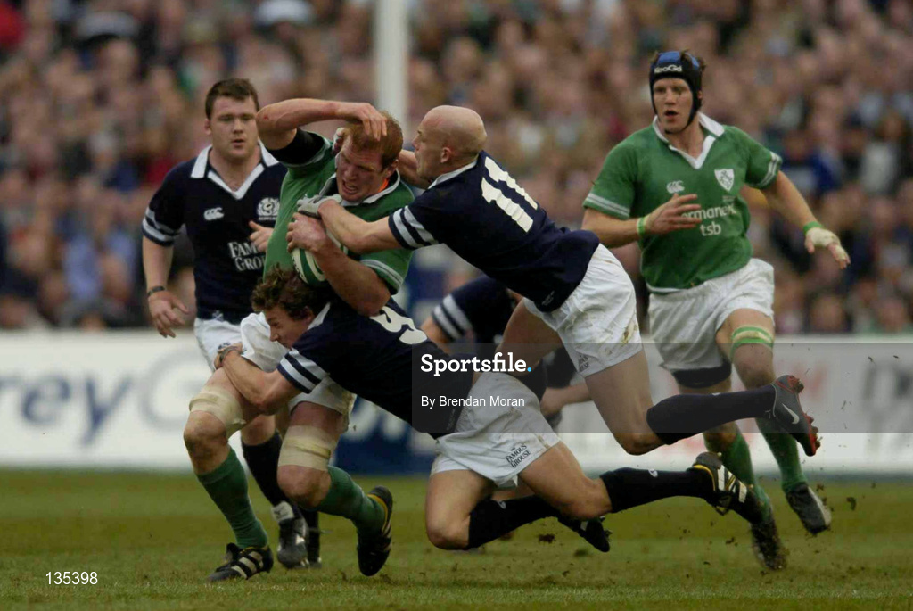 27 March 2004; Paul O'Connell of Ireland is tackled by Scotland players Chris Cusiter, 9, and Simon Webster during the RBS Six Nations Rugby Championship match between Ireland and Scotland at Lansdowne Road in Dublin. Photo by Brendan Moran/Sportsfile