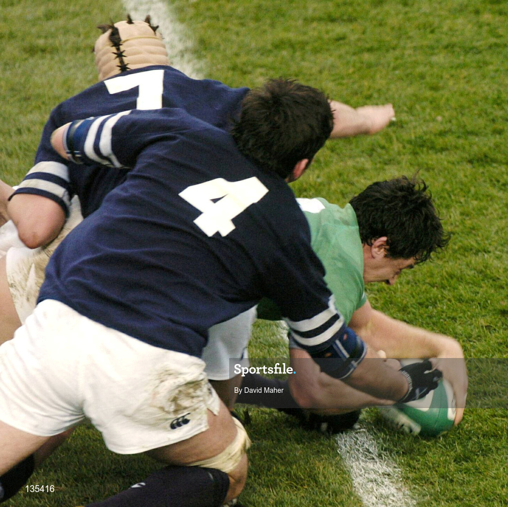 27 March 2004; David Wallace of Ireland goes over to score his side's third try despite the tackle of Cameron Mather and Scott Murray of Scotland during the RBS Six Nations Rugby Championship match between Ireland and Scotland at Lansdowne Road in Dublin. Photo by David Maher/Sportsfile