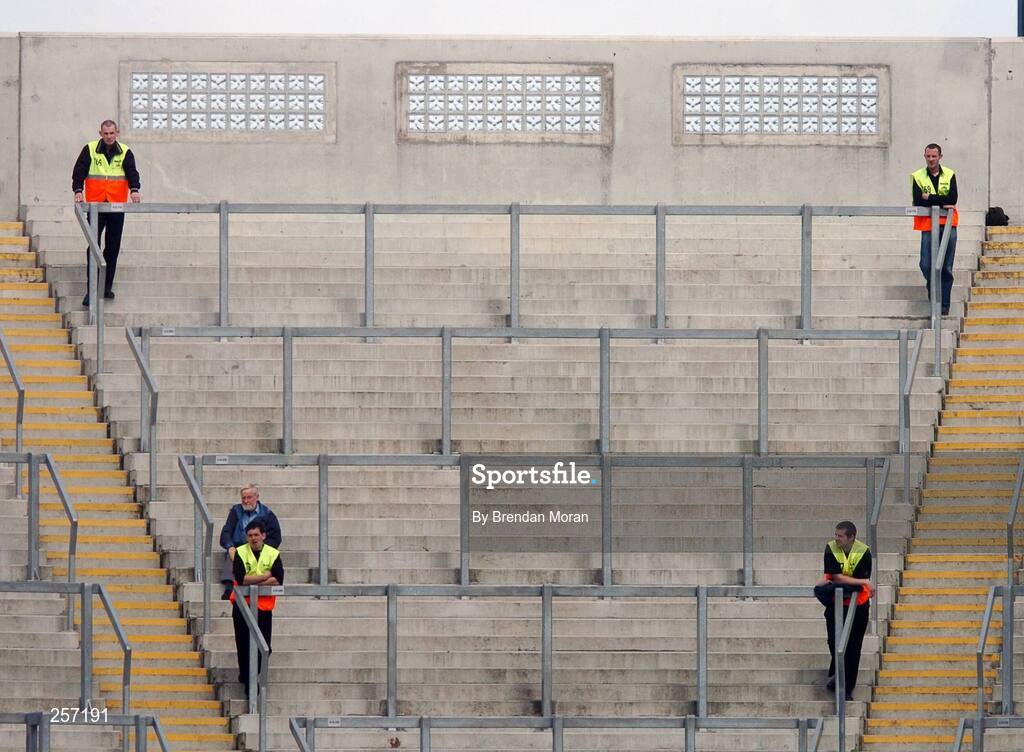 15 July 2007; A lone Dublin supporter, flanked by 4 stewards, sits on Hill 16 before the game. Bank of Ireland Leinster Senior Football Championship Final, Dublin v Laois, Croke Park, Dublin. Picture credit: Brendan Moran / SPORTSFILE