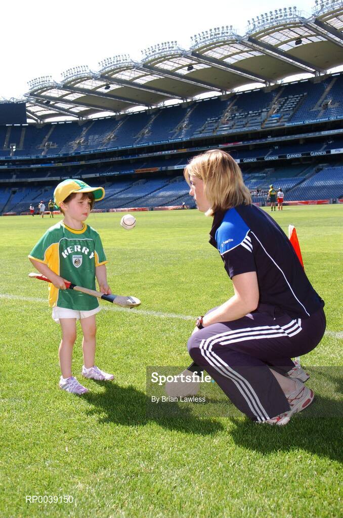 31 July 2007; Croke Park became a theatre of dreams today as over 250 young Camogie stars of the future enjoyed a first experience of playing on the hallowed turf. U-14 players on the Coillte Development Squads from Clare, Derry, Kerry, Laois, Louth, Monaghan, Tipperary and Westmeath were granted the rare opportunity to hone their skills at headquarters as part of the Camogie Association’s national programme to develop the sport at juvenile level. The partnership with Coillte, supported by the Irish Sports Council, enables top level coaching and encouragement for young girls throughout the eight designated counties. At the tournament is Cork camogie star Mary O'Connor, Director of Camogie Development, with Caoimhe Spillane, age 5, from Abbeydorney, Kerry. 2007 Coillte U14 Camogie Development Squads tournament, Croke Park, Dublin. Picture credit: Brian Lawless / SPORTSFILE