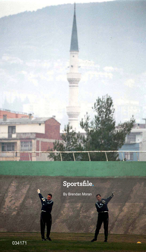 16 November 1999; Goalkeeper Dean Kiely, left, and goalkeeping coach Packie Bonner warm-up, with a view of a local mosque behind, during a Republic of Ireland training session at Veledrom Stadium in Bursa, Turkey. Photo by Brendan Moran/Sportsfile *** Local Caption ***