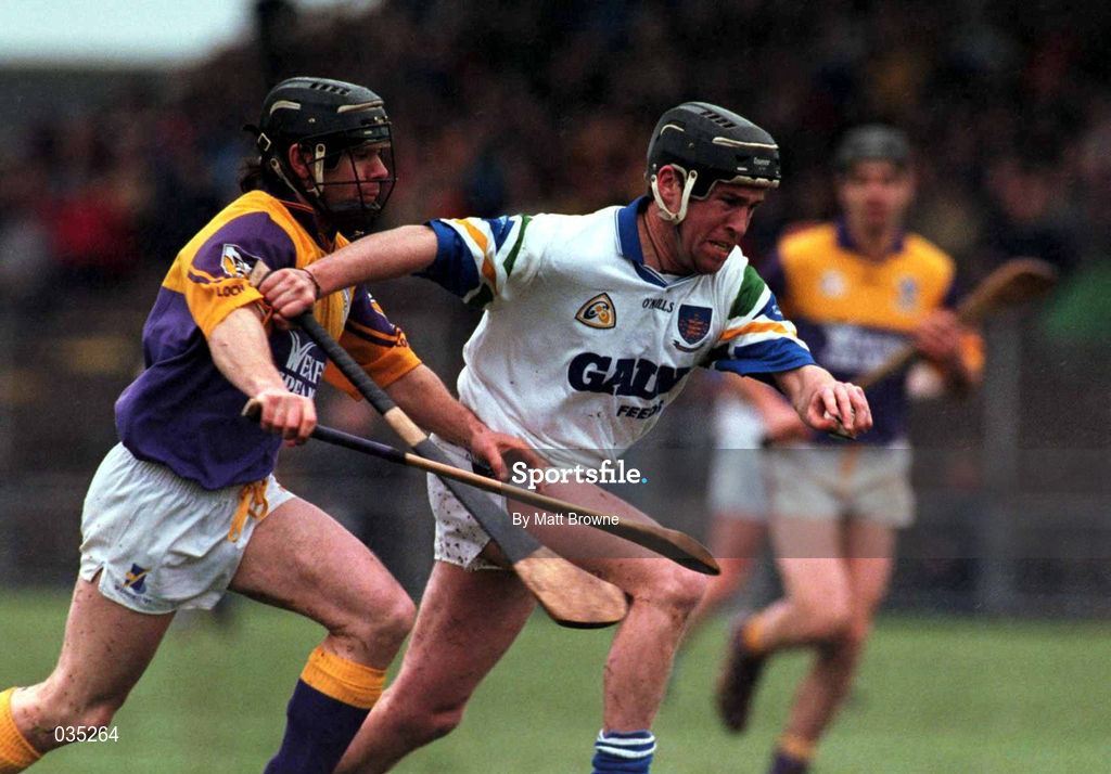 27 February 2000; Dave Bennett of Waterford is tackled by Sean Flood of Wexford during the Church & General National Hurling League Division 1B Round 2 match between Waterford and Wexford at Walsh Park in Waterford. Photo by Matt Browne/Sportsfile