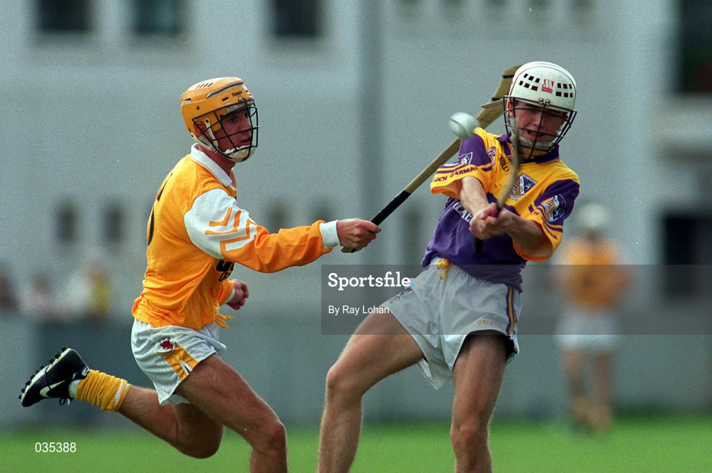 24 July 1999; Des Mythen of Wexford in action against Ciarán Herron of Antrim during the All-Ireland Minor Hurling Championship Quarter-Final match between Antrim and Wexford at Parnell Park in Dublin. Photo by Ray Lohan/Sportsfile