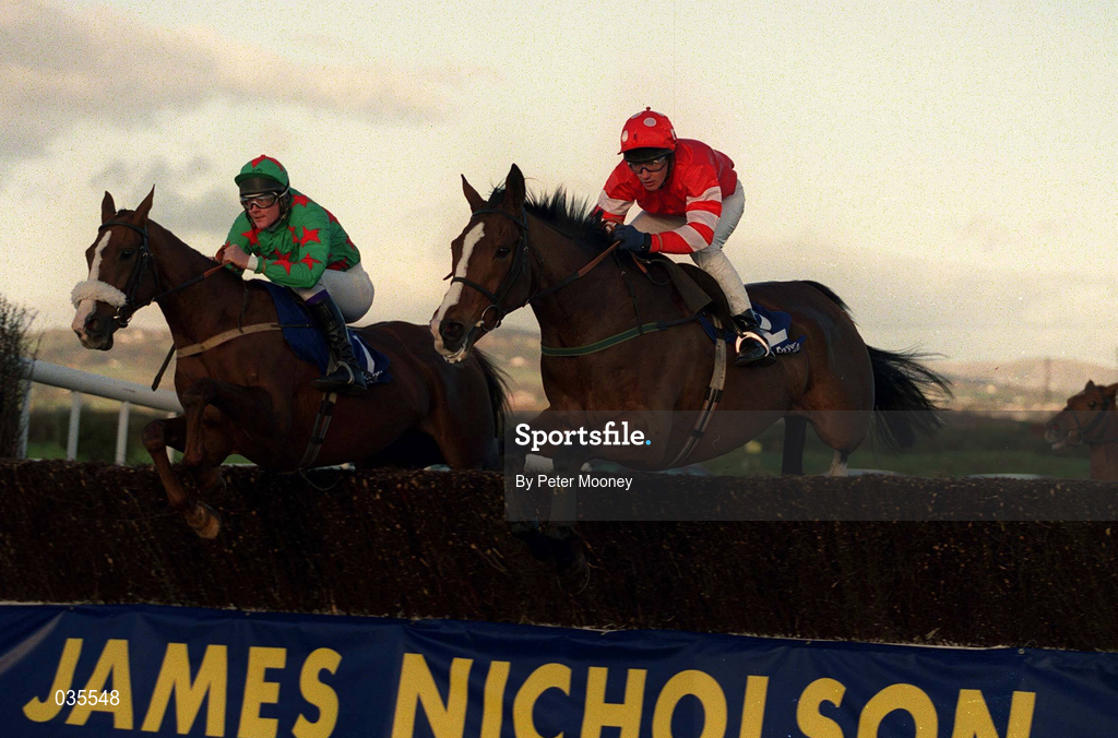 6 November 1999; Florida Pearl, right, with Paul Carberry up alongside Dorans Pride, with Paul Hourigan up, clear the last - first time round - during the James Nicholson Wine Merchant Steplechase at the Down Royal Racecourse in Lisburn, Down. Photo by Peter Mooney/Sportsfile