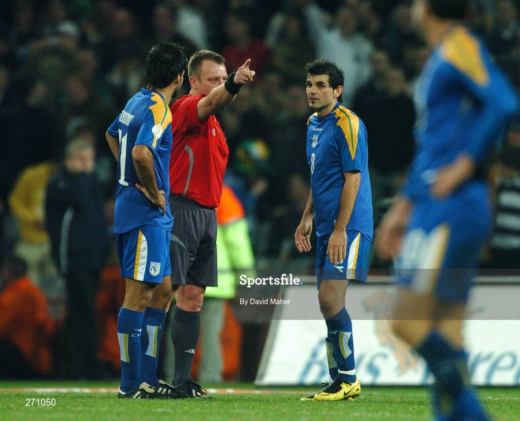17 October 2007; Referee Mikko Vuorela, Finland, who is refereeing his last game, issues a red card to Marios Ilia, Cyprus, right, as his team-mate Paraskevas Christou watches on. 2008 European Championship Qualifier, Republic of Ireland v Cyprus, Croke Park, Dublin. Picture credit; David Maher / SPORTSFILE