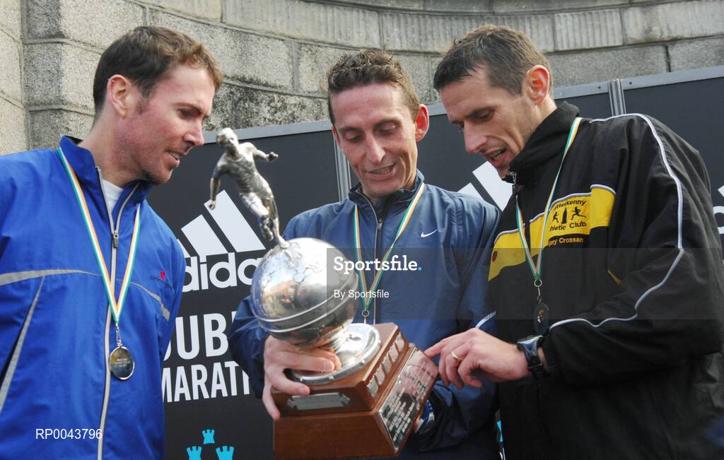 29 October 2007; 1st place men's Irish winner Michael O'Connor, center, from Galway City Harriers views his trophy with 2nd place men's Irish Cian McLoughlin, left, from Clonliffe Harriers Athletic Club and 3rd place men's Irish Gary Crossan from Letterkenny Athletic Club. adidas Dublin City Marathon 2007, Merrion Square, Dublin. Photo by Sportsfile  *** Local Caption ***