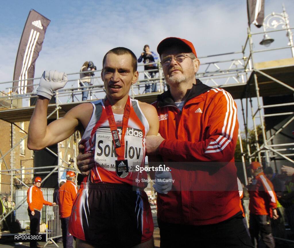 29 October 2007; The men's winner Aleksey Sokolov, from Russia, celebrates as Dave Humphreys, Organising Committee, ushers him to the cool down area after the race. adidas Dublin City Marathon 2007, Merrion Square, Dublin. Picture credit: Stephen McCarthy / SPORTSFILE