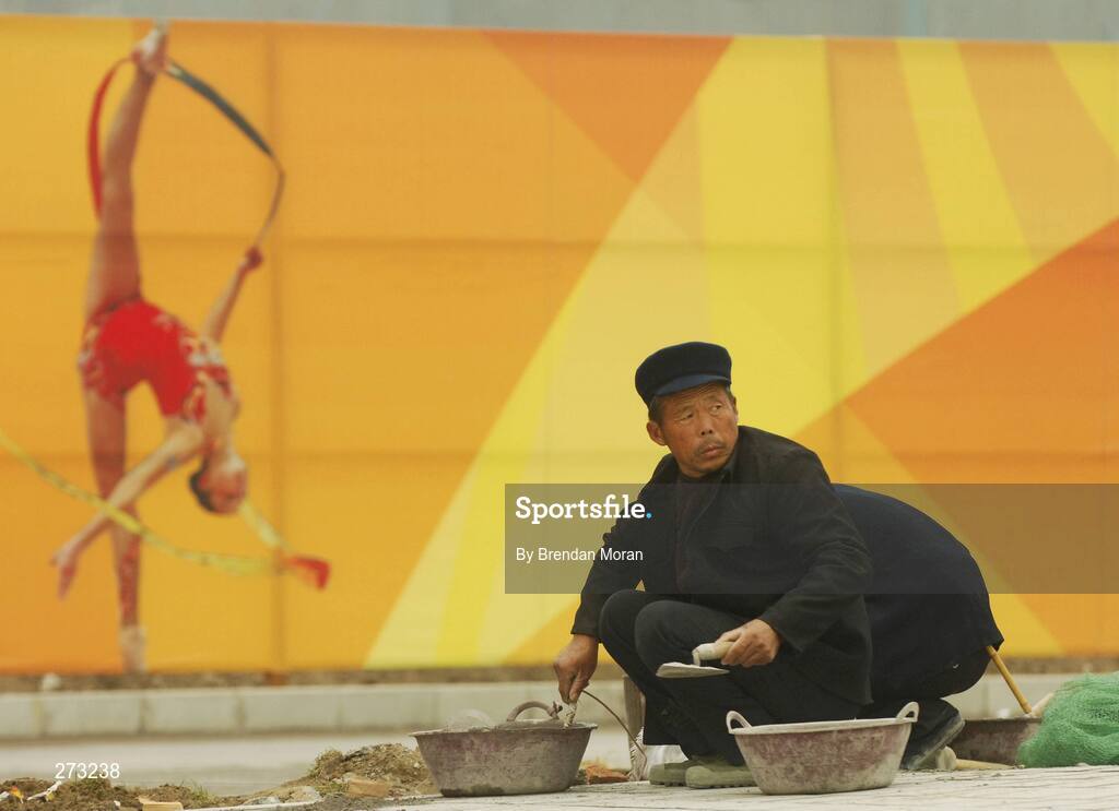 12 November 2007; A worker goes about his business near the Beijing University of Technology Gymnasium during preparations in Beijing ahead of the 2008 Summer Olympic Games. The 2008 Summer Olympics, officially known as the Games of the XXIX Olympiad, will be take place from the 8th August 2008 to 24th August 2008, at the Beijing National Stadium in Beijing, China. Beijing, China. Picture credit: Brendan Moran / SPORTSFILE