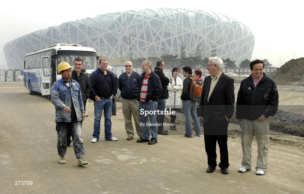 12 November 2007; A construction worker walks past a group of Irish journalists neat the National Stadium during preparations in Beijing ahead of the 2008 Summer Olympic Games. The 2008 Summer Olympics, officially known as the Games of the XXIX Olympiad, will be take place from the 8th August 2008 to 24th August 2008, at the Beijing National Stadium in Beijing, China. Beijing, China. Picture credit: Brendan Moran / SPORTSFILE *** Local Caption ***