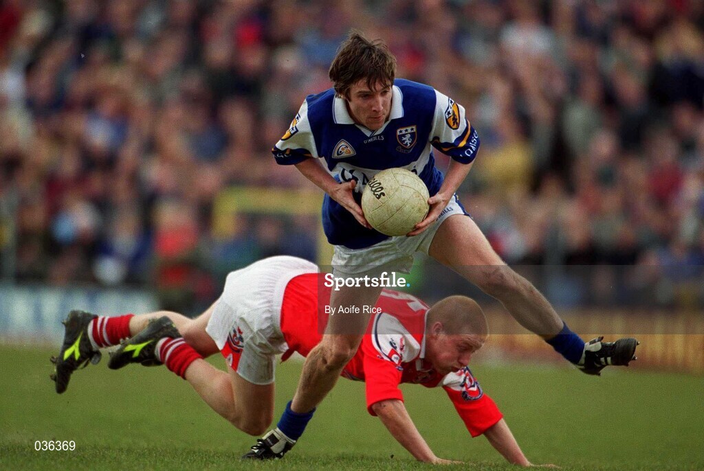 23 April 2000; Colm Parkinson of Laois is tackled by Peter McGinnity of Louth during the Church & General National Football League Division 2 Semi-Final match between Louth and Laois at Cusack Park in Mullingar, Westmeath. Photo by Aoife Rice/Sportsfile