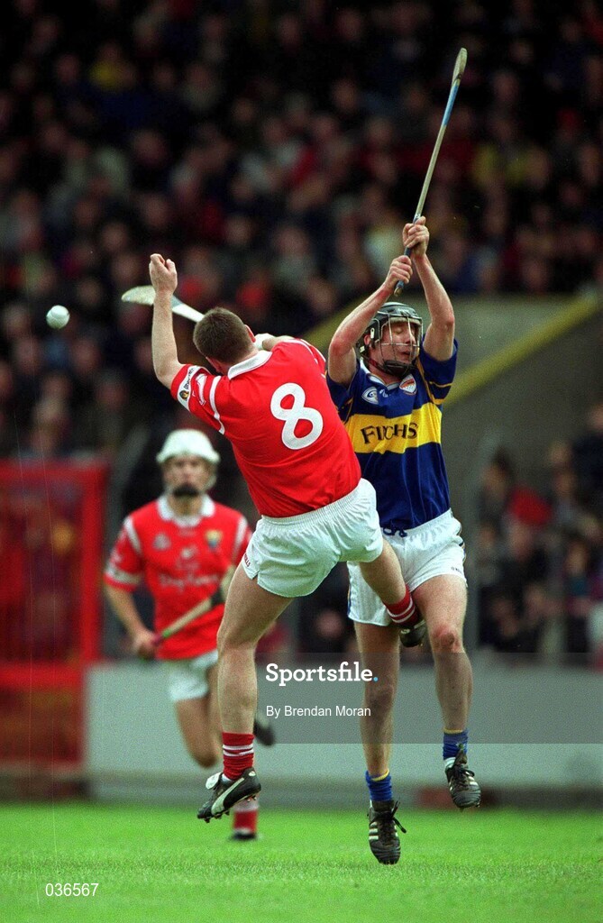 2 April 2000; Eddie Enright of Tipperary in action against Mark Landers of Cork during the Church & General National Hurling League Division 1B match between Cork and Tipperary at Páirc Uí Chaoimh in Cork. Photo by Brendan Moran/Sportsfile