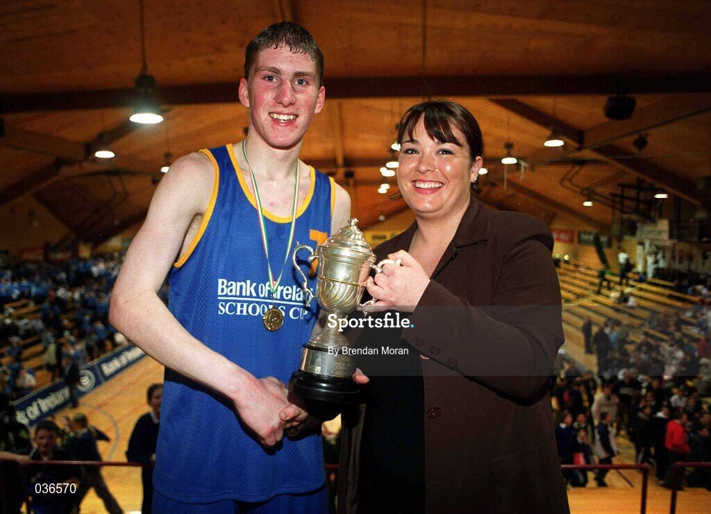 8 February 2000; St Laurence Loughlinstown captain Eddie Kelly is presented with the cup by Ann Casey of  Bank of Ireland following the Bank of Ireland Schools Cup Boys' B Final match between St Laurence Loughlinstown and St Mary's Moyderwel at National Basketball Arena in Tallaght, Dublin. Photo by Brendan Moran/Sportsfile