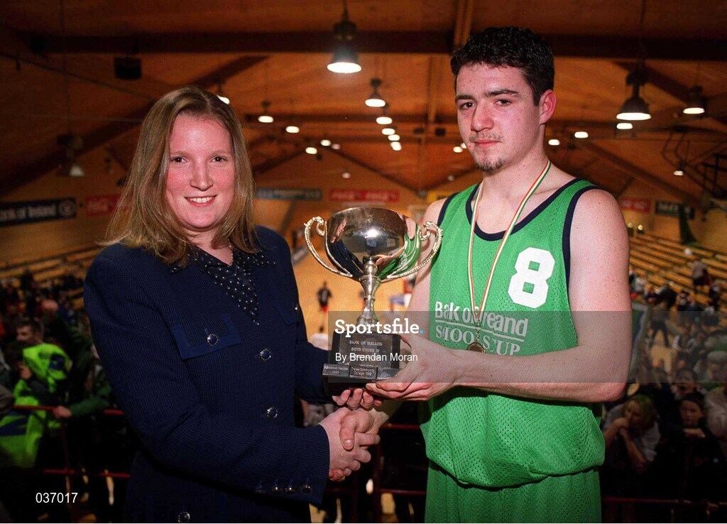 9 February 2000; Colaiste Mhuire Crosshaven captain Jonathan Fitzgibbon is presented with the cup by Catherine Roche of Bank of Ireland following the Bank of Ireland Schools Cup Boys' C Final match between Colaiste Mhuire Crosshaven and Carrick-On-Shannon CS at National Basketball Arena in Tallaght, Dublin. Photo by Brendan Moran/Sportsfile