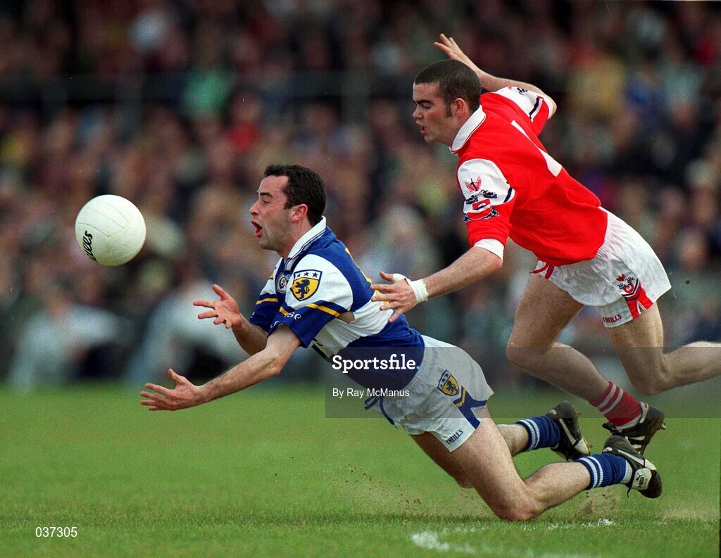 23 April 2000; Mickey Graham of Laois is tackled by James Brady of Louth during the Church & General National Football League Division 2 Semi-Final match between Louth and Laois at Cusack Park in Mullingar, Westmeath. Photo by Ray McManus/Sportsfile