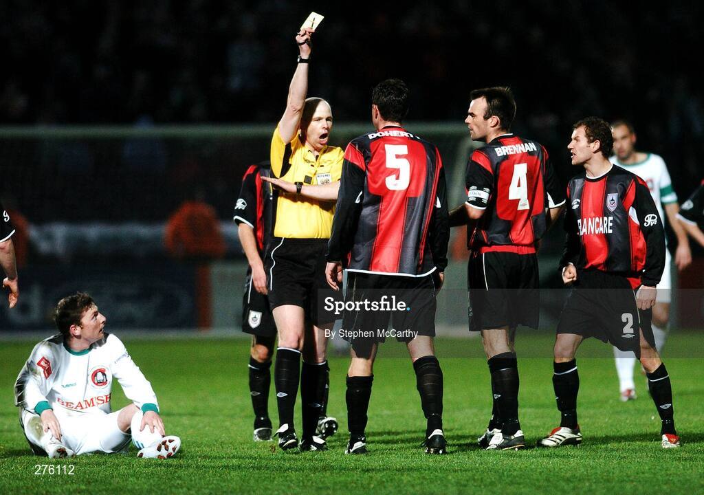 2 December 2007; Referee David McKeon issues Kevin Dohery, Longford Town, with a yellow card as team-mate's Damien Brennan, 4, and Pat Sullivan remonstrate and Denis Behan, Cork City, watches on from the ground. FAI Ford Cup Final, Cork City v Longford Town, RDS, Ballsbridge, Dublin. Picture credit; Stephen McCarthy / SPORTSFILE