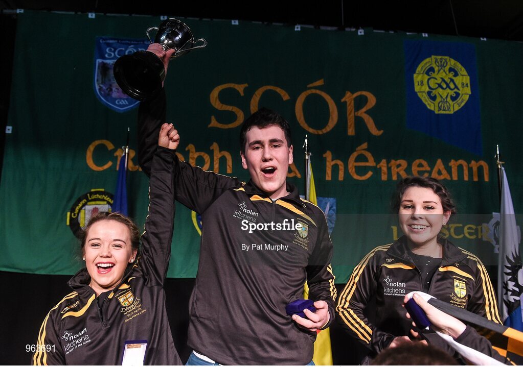 14 February 2015; The The Downs, Co. Westmeath, team members, from left, Niamh Rowan, Paul Lynam and Serena Wynne celebrate with the trophy after winning the Leiriu competition during the All-Ireland Scór na nÓg Championship Finals 2015. Citywest Hotel, Saggart, Co. Dublin. Picture credit: Pat Murphy / SPORTSFILE