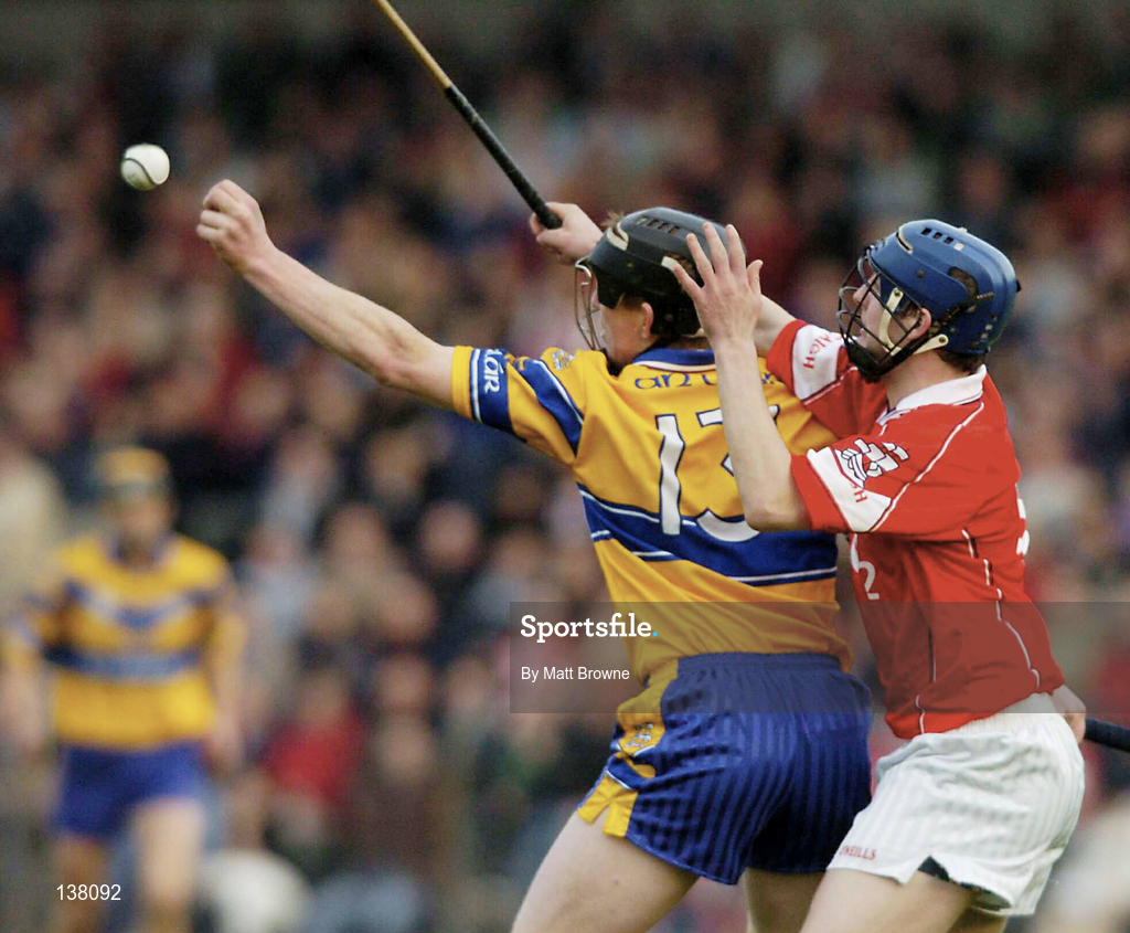 24 April 2004; Niall Gilligan of Clare in action against Cian O'Connor of Cork during the Allianz National Hurling League Group 1 Round 3 match between Cork and Clare at Páirc U’ Rinn in Cork. Photo by Matt Browne/Sportsfile