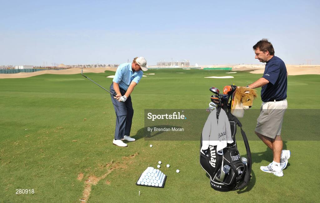 28 January 2008; Ernie Els of South Africa, watched by his caddy JP Fitzgerald, from Co. Clare, during the opening day of The Els Course in the new Dubai Sports City. Dubai, United Arab Emirates. Picture credit: Brendan Moran / SPORTSFILE *** Local Caption ***
