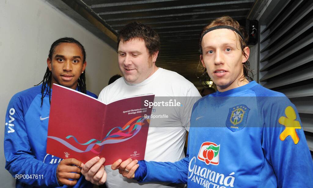 5 February 2008; Pictured is Special Olympics athlete Joe Nagle, from Islandbridge, in Dublin, showing the Special Olympics Ireland Strategy 2008-2010 to Manchester United's Anderson and Liverpool's Lucas of the Brazil International soccer squad. The strategy is available to download at www.specialolympics.ie. Croke Park, Dublin. Photo by Sportsfile