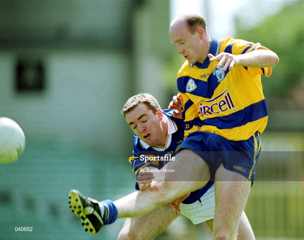 25 June 2000; Donal O'Sullivan of Clare gets his shot in despite the challenge of Eamon Hanrahan of Tipperary during the Bank of Ireland Munster Senior Football Championship Semi-Final match between Clare and Tipperary at the Gaelic Grounds in Limerick. Photo by Brendan Moran/Sportsfile
