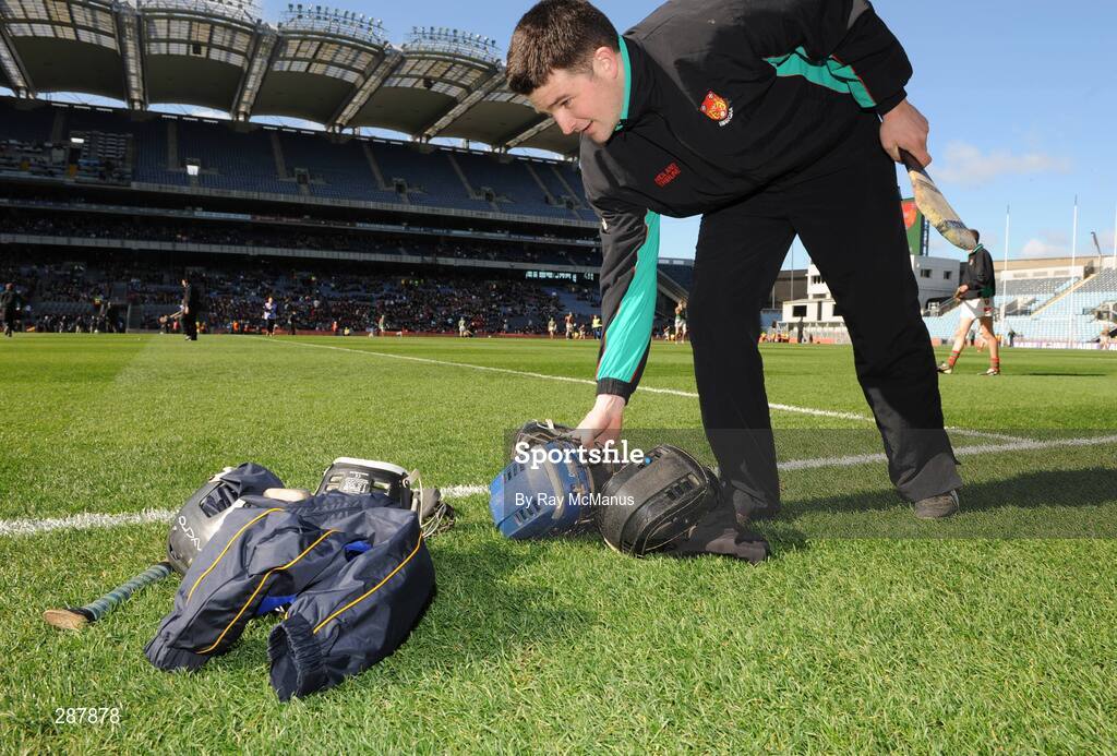 17 March 2008; A Birr official collects the helmets and jackets left on the side of the pitch. AIB All-Ireland Club Hurling Final, Portumna v Birr, Croke Park, Dublin. Picture credit; Ray McManus / SPORTSFILE
