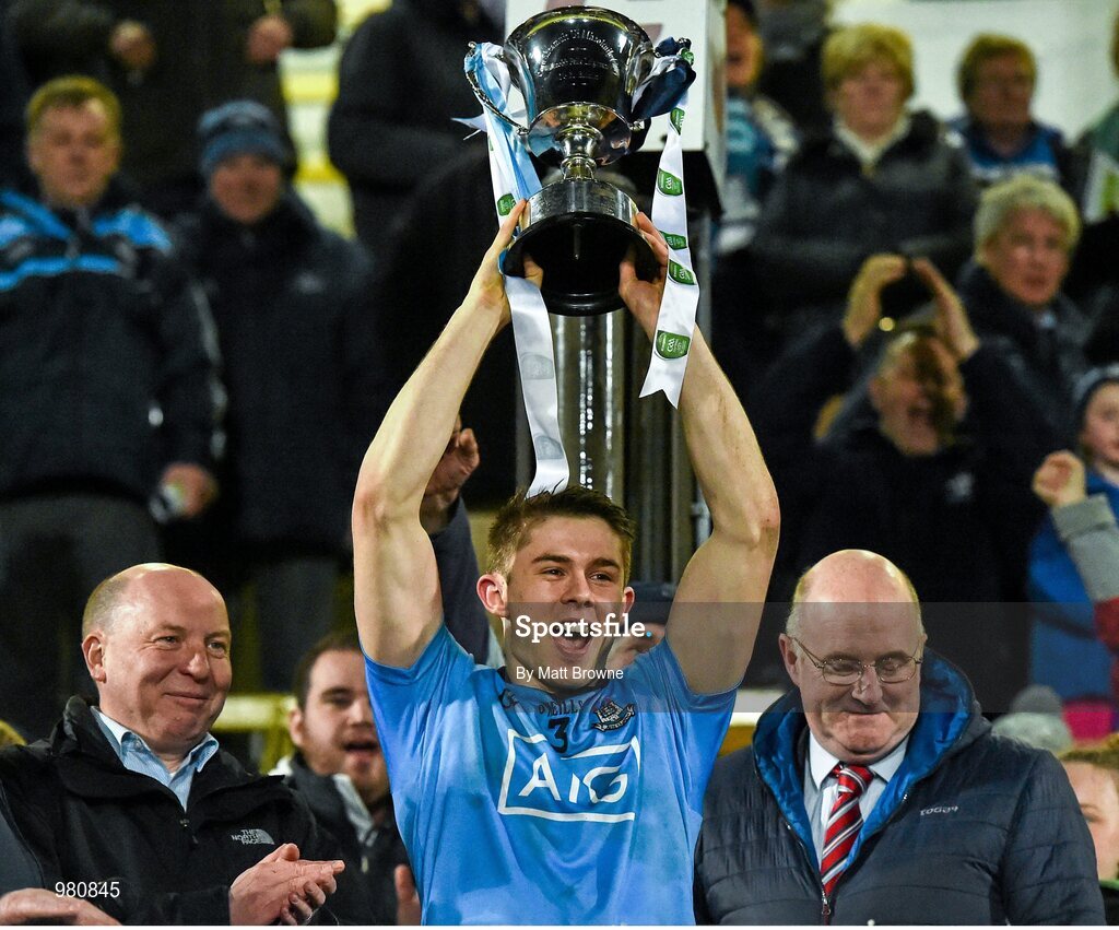 2 April 2015; Dublin captain David Byrne lift the cup, in the company of Fintan Slye, left, CEO EirGrid, and Chairman of the Leinster Council John Horan. EirGrid Leinster U21 Football Championship Final, Dublin v Kildare. Páirc Táilteann, Navan, Co. Meath. Picture credit: Matt Browne / SPORTSFILE