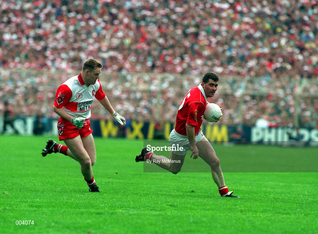 19 September 1993; Cork captain Mick McCarthy races clear from Dermot Heaney of Derry during the All-Ireland Senior Football Championship Final match between Derry and Cork at Croke Park in Dublin. Photo by Ray McManus/Sportsfile
