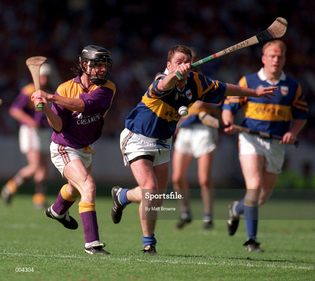 17 August 1997;Sean Flood of Wexford in action against Liam McGrath of Tipperary during the GAA All-Ireland Senior Hurling Championship Semi-Final match between Tipperary and Wexford at Croke Park in Dublin. Photo by Matt Browne/Sportsfile