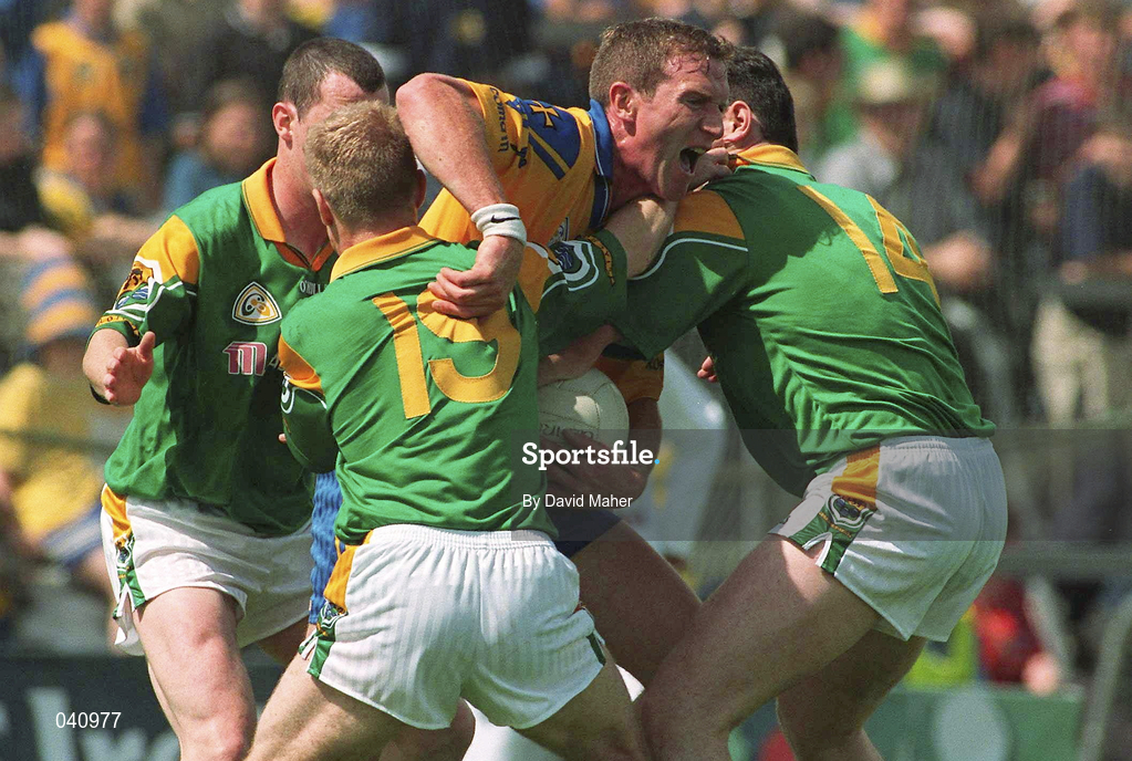 2 July 2000; Ronan Owens of Roscommon is tackled by Leitrim players, Aidan Rooney, Padraig Kenny and Adrian Cullen during the Bank of Ireland Connacht Senior Football Championship Semi-Final match between Roscommon and Leitrim in Dr. Hyde Park in Roscommon. Photo by David Maher/Sportsfile