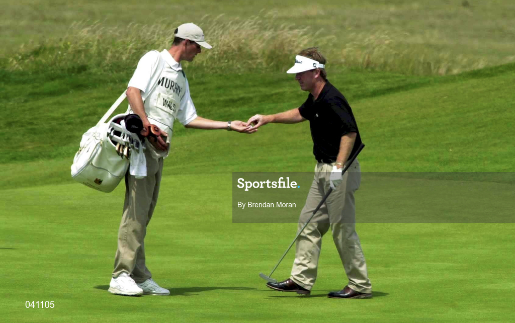 29 June 2000; Philip Walton of Ireland hands the ball to his caddie after finishing on the eighth green during the first day of the Murphy's Irish Open Golf Championship at Ballybunion Golf Club in Kerry. Photo by Brendan Moran/Sportsfile