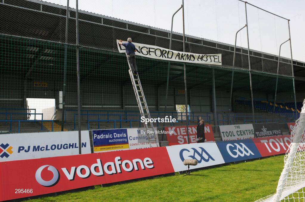 11 May 2008; Paddy Madden, under the watchful eyes of hotel manager Brendan Downes, erects a sign in favour of the Longford Arms Hotel before the game. GAA Football Leinster Senior Championship, Longford v Westmeath, Pearse Park, Longford. Picture credit: Ray McManus / SPORTSFILE