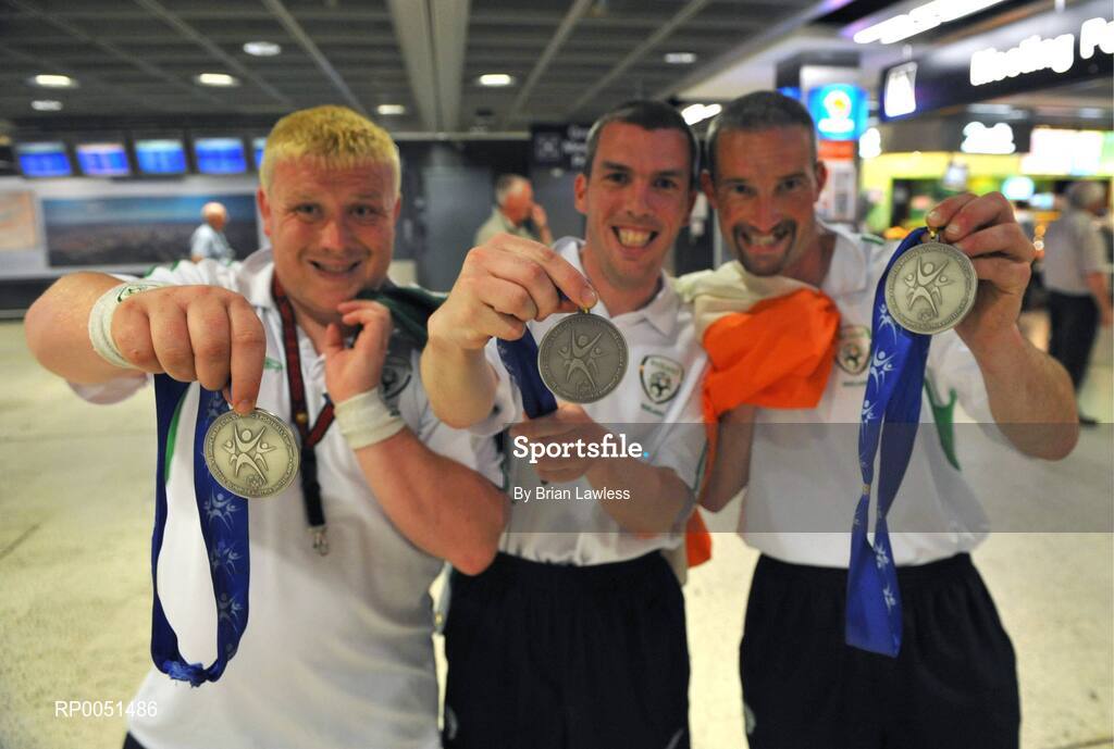 8 May 2008; Team Ireland players, from left, Thomas Leonard, James Murphy and Derek Owens show of their medals on arrival in Dublin Airport. TEAM Ireland returned from the Special Olympics European Football Tournament which took place in Switzerland as competition runners up having lost out to Latvia in the finals by one goal.  24 countries in total took part in the tournament to celebrate European Football Week, supported by UEFA. Dublin Airport. Picture credit: Brian Lawless / SPORTSFILE