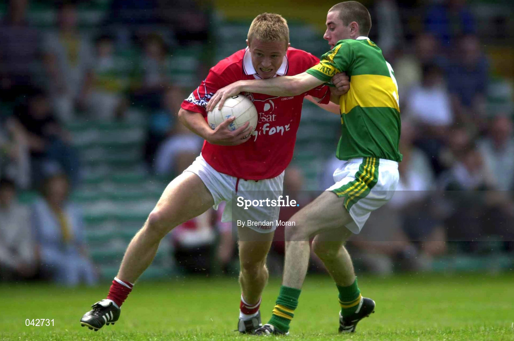16 July 2000;Conrad Murphy of Cork in action against TJ Hogan of Kerry  during the Munster Minor Football Championship Final between Kerry and Cork at the Gaelic Grounds in Limerick. Photo By Brendan Moran/Sportsfile