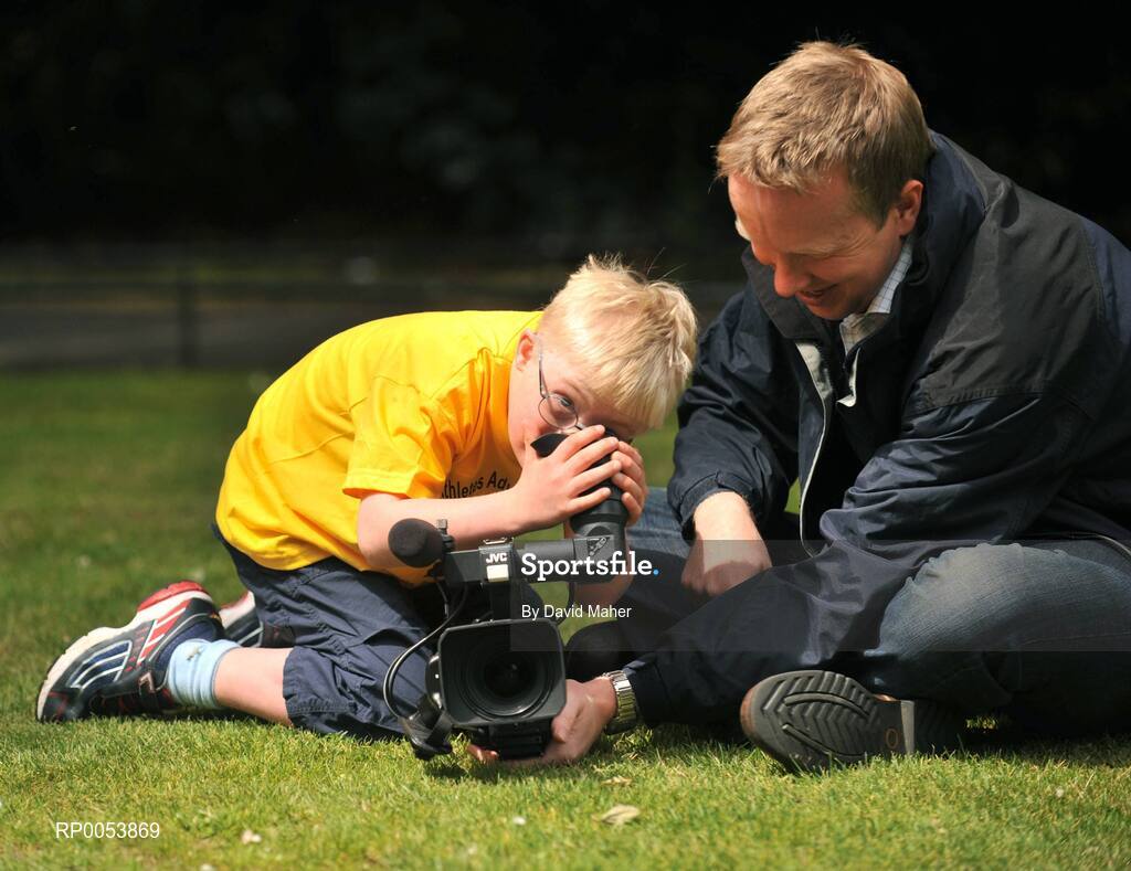17 June 2008; Nine-year-old Special Olympics Athlete Andrew McCarthy, from Foxrock, Dublin, checks out the camera of RTE's Philip Bromwell at the launch of the Athletics Advocate for Africa conference, to be hosted by Special Olympics Ireland from 22-26 June in Dublin. St. Stephen’s Green, Dublin. Picture credit: David Maher / SPORTSFILE